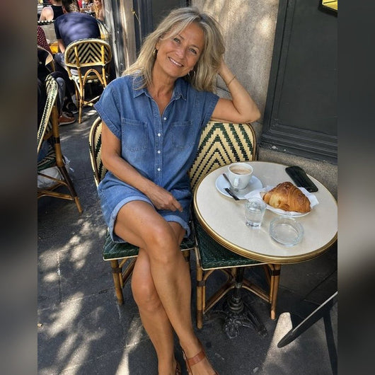 Woman wearing the denim romper at a cafe