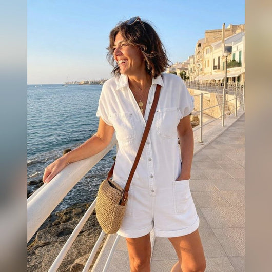 Woman wearing the white romper by the sea